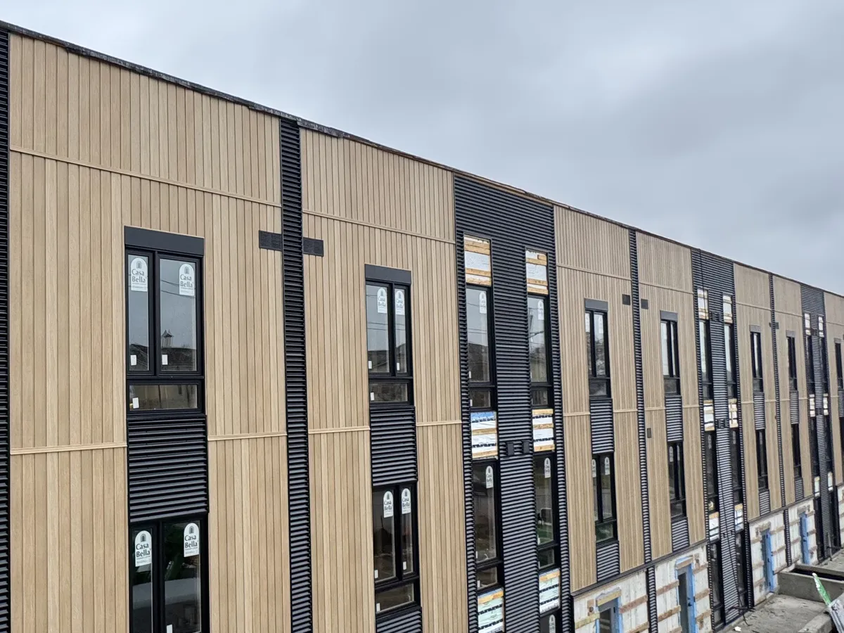 Mixed-use facade with wood-look cladding and metal