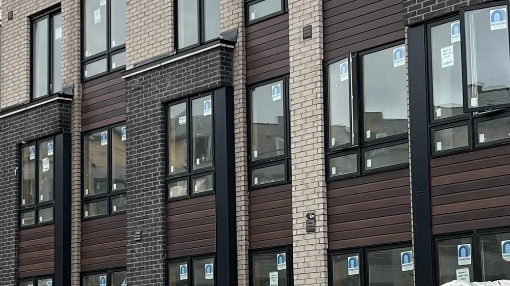 Multi-unit facade with wood-look cladding and brick