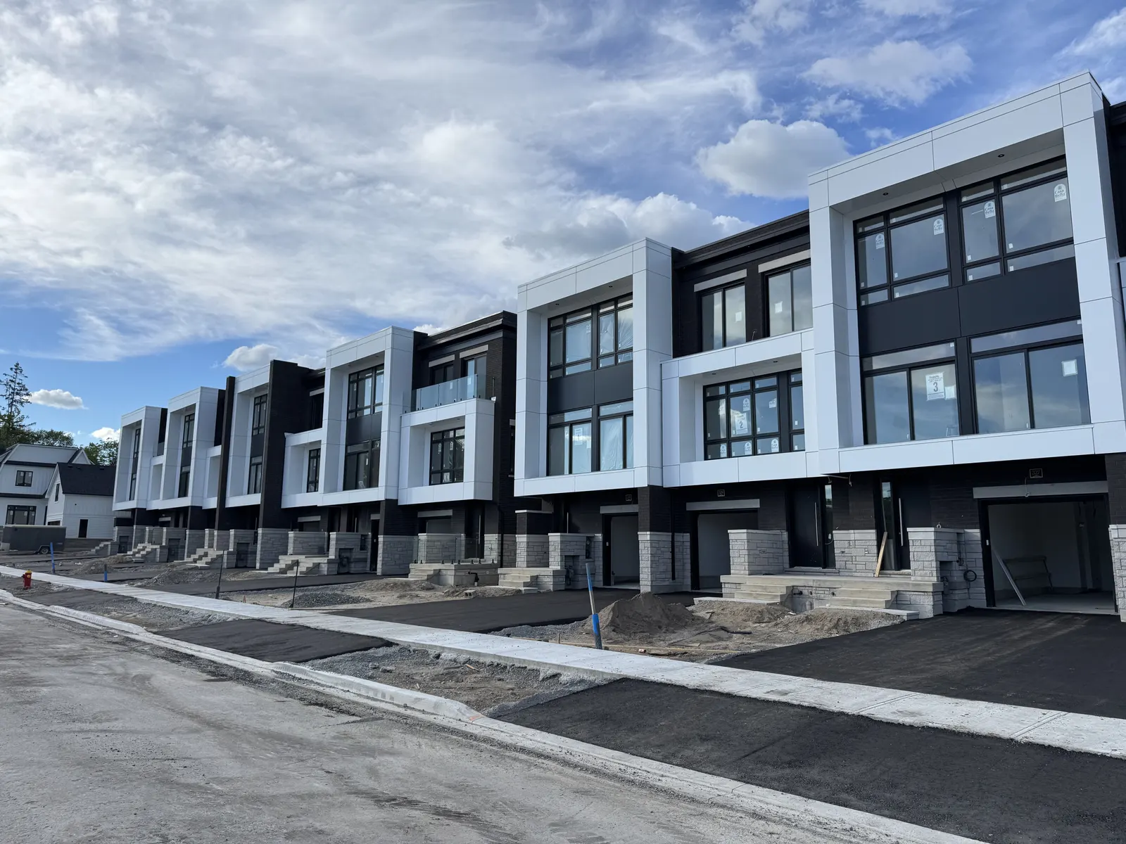 The same townhome row after cladding installation